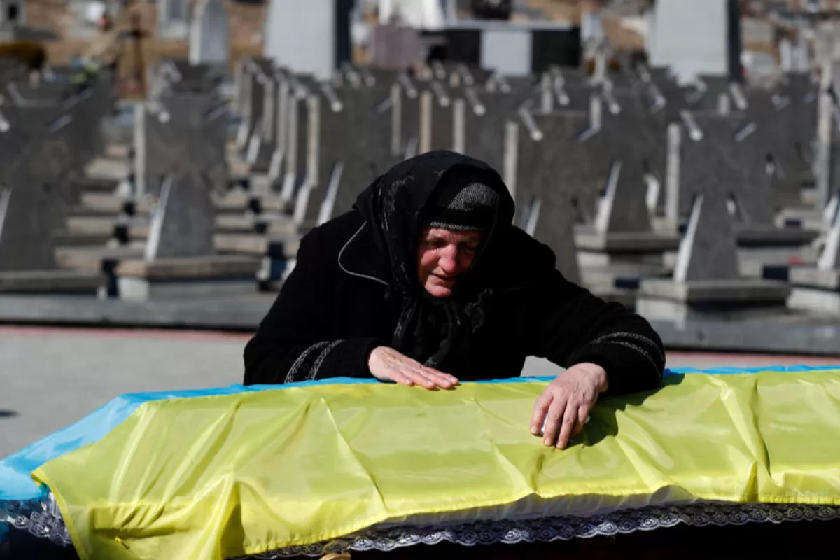 The mother of Ukrainian army officer Ivan Skrypnyk, killed in action on 13 March, mourns on her son's coffin during a funeral service at the military graveyard in Lviv, Ukraine, 17 March 2022, as the Russian invasion of Ukraine enters its fourth week.