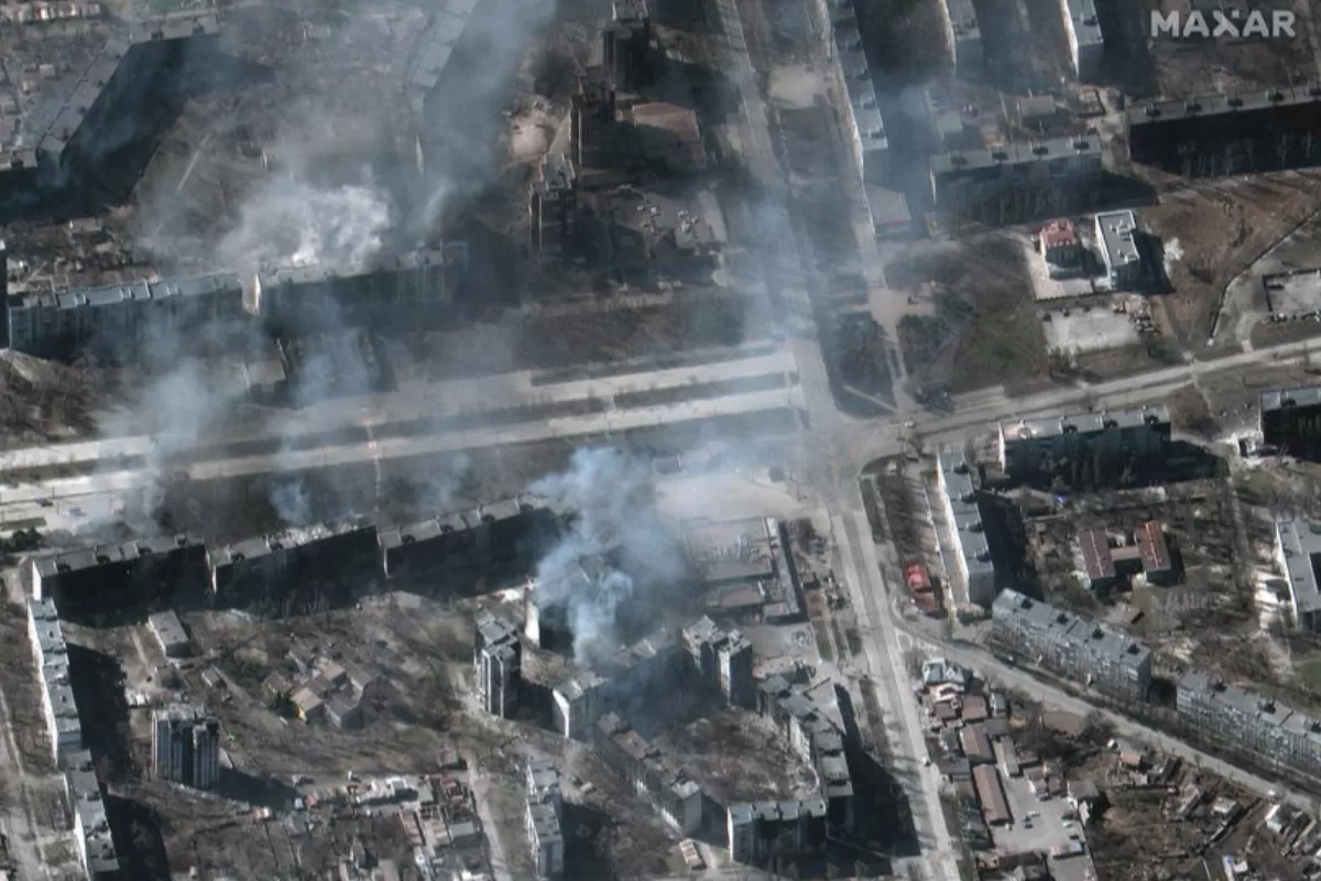A handout satellite image made available by Maxar Technologies shows buildings on fire, in Mariupol, Ukraine, 22 March 2022.