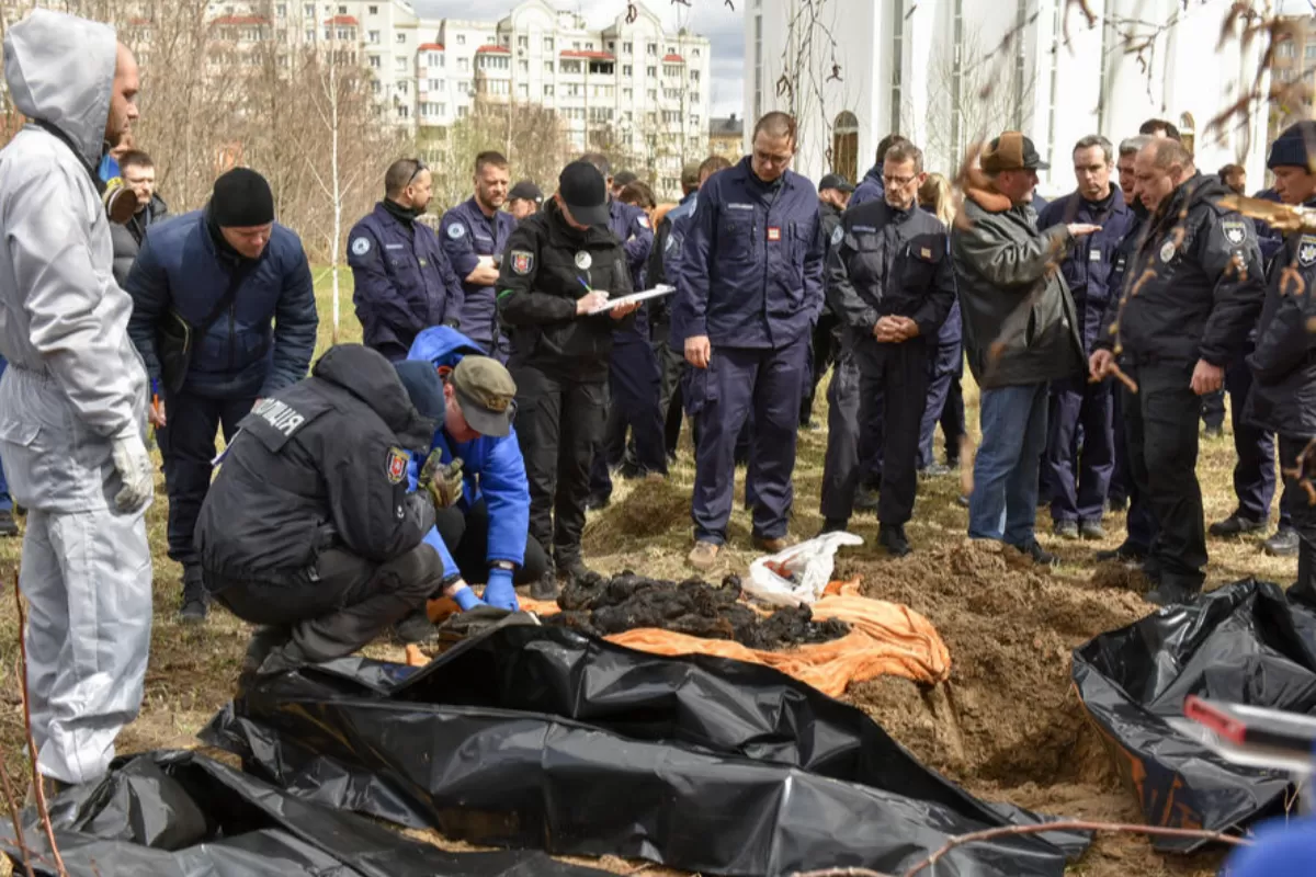 Members of an international team of war crimes prosecutors and Prosecutor General of Ukraine Iryna Venediktova (C) during a visit to a mass grave in Bucha, Kyiv (Kiev) area, Ukraine, 12 April 2022.