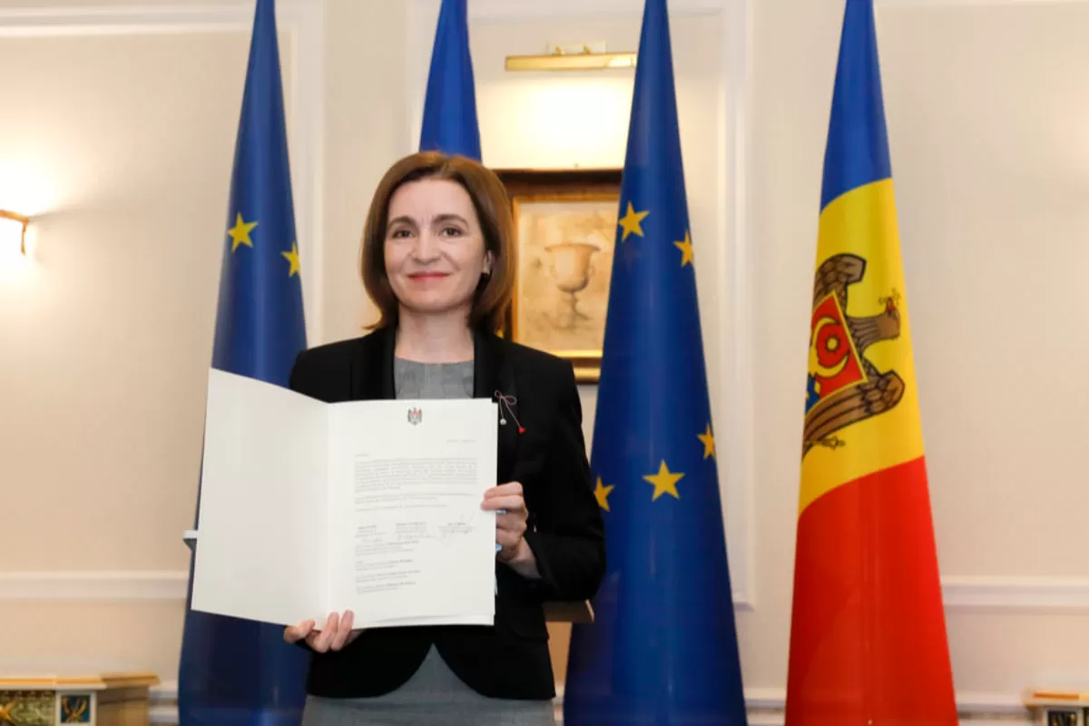 Moldovan President Maia Sandu poses with the document for the media in the State Residence building in Chisinau, Moldova, 03 March 2022. President Sandu along with the Parliament Speaker and the country's Prime Minister shortly before had signed an application for membership in the European Union.