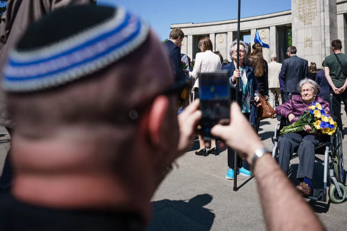 Ukrainian refugee Aia Iolina who sits in a wheelchair is photographed by her grandson Mykhaylo who wears a kippah at the Soviet War Memorial in Berlin, Germany, 08 May 2022.