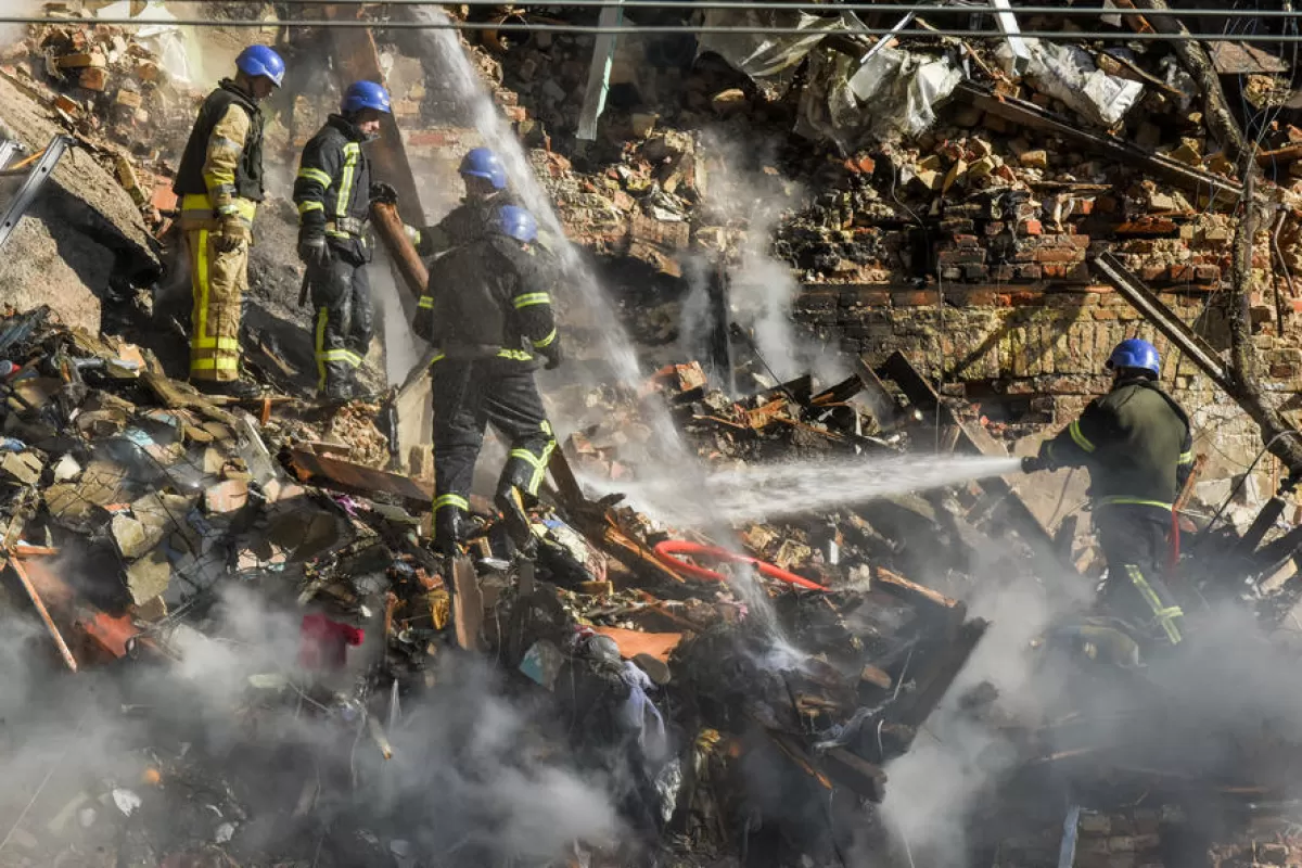 Ukrainian rescuers work at the clean the rubble on destroyed residential building by Russian drone attack in downtown Kyiv , Ukraine, 17 October 2022, amid the Russian invasion.