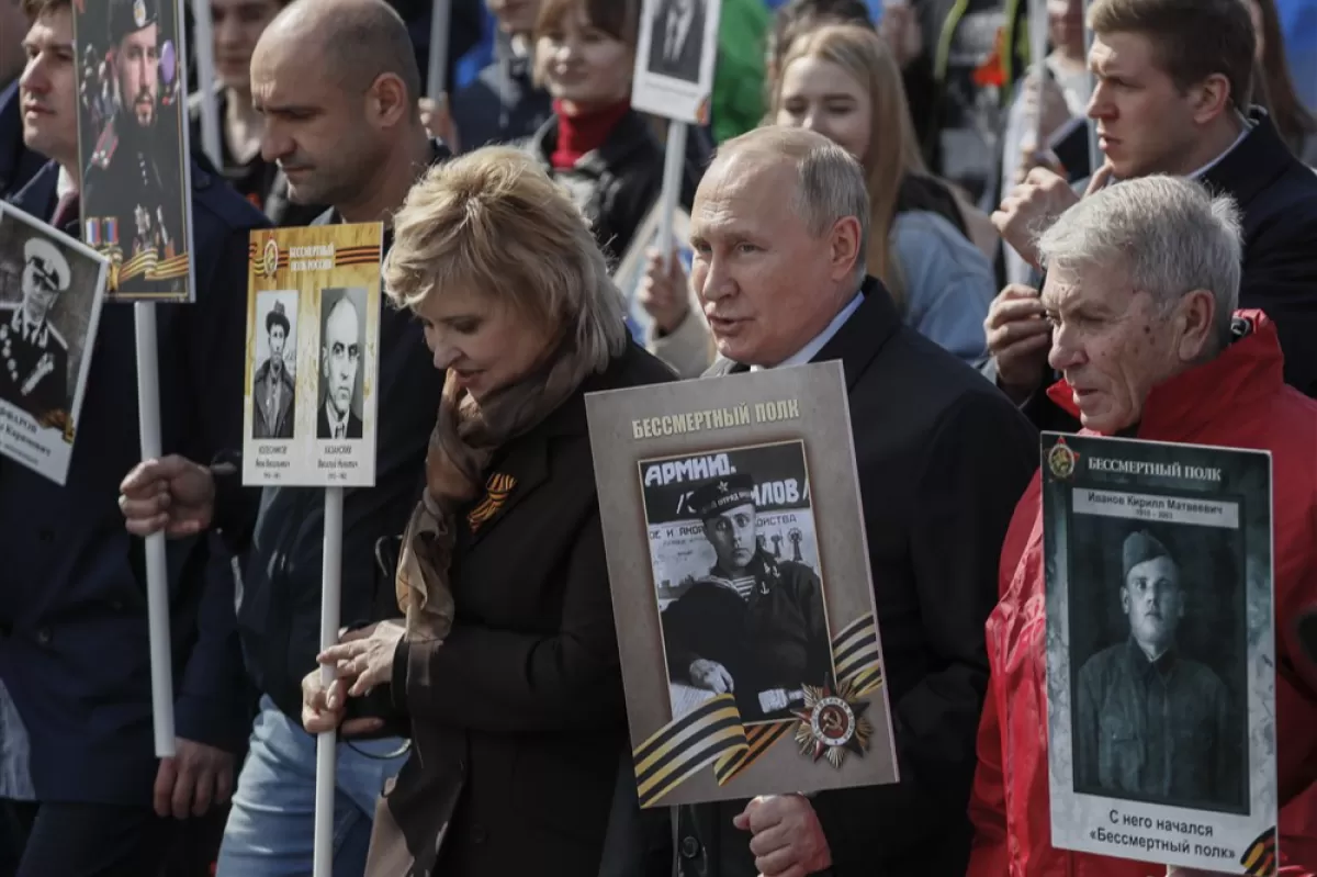 Donetsk People's Republic Militia officer Artyom Zhoga (2-L) holds the portrait of his son, Hero of Russia Vladimir Zhoga, next to Russian President Vladimir Putin (2-R), during an Immortal Regiment memorial in Moscow, Russia, 09 May 2022.