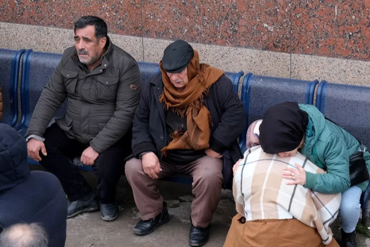 Relatives of earthquake victims gather outside a state hospital morgue in Diyarbakir