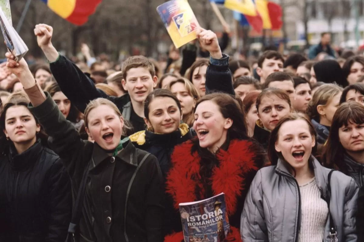 Moldovan students shouts anti government slogans as they wave Romanian history books during a rally in downtown Chisinau, Wednesday 13 February 2002.