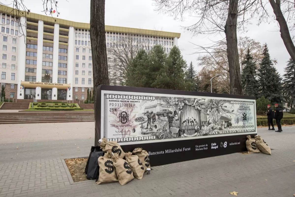 Сумки с фальшивыми деньгами и баннер размещены перед парламентом в поддержку расследования "украденного миллиарда", в Кишиневе, Молдова, 14 ноября 2019 года.