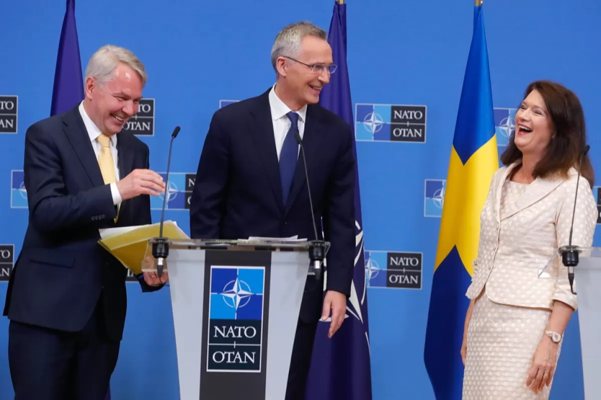 NATO Secretary General Jens Stoltenberg (C), Finland's Minister of Foreign Affairs Pekka Haavisto (L) and Sweden's Minister of Foreign Affairs Ann Linde react at the end of a joint press conference after the signature of the accession protocols to NATO of Finland and Sweden, at NATO headquarters in Brussels, Belgium, 05 July 2022.