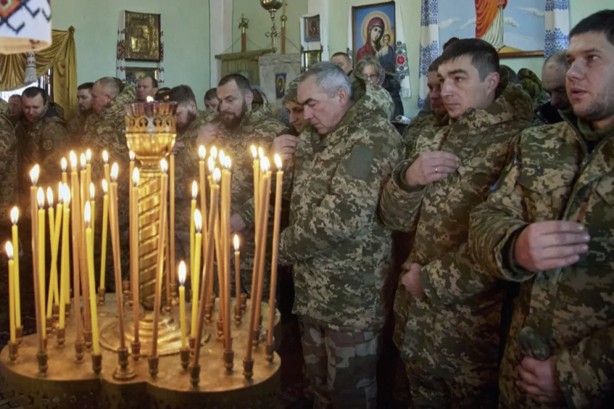 Ukrainian soldiers attend a Christmas service in an Orthodox church in Glushkivka