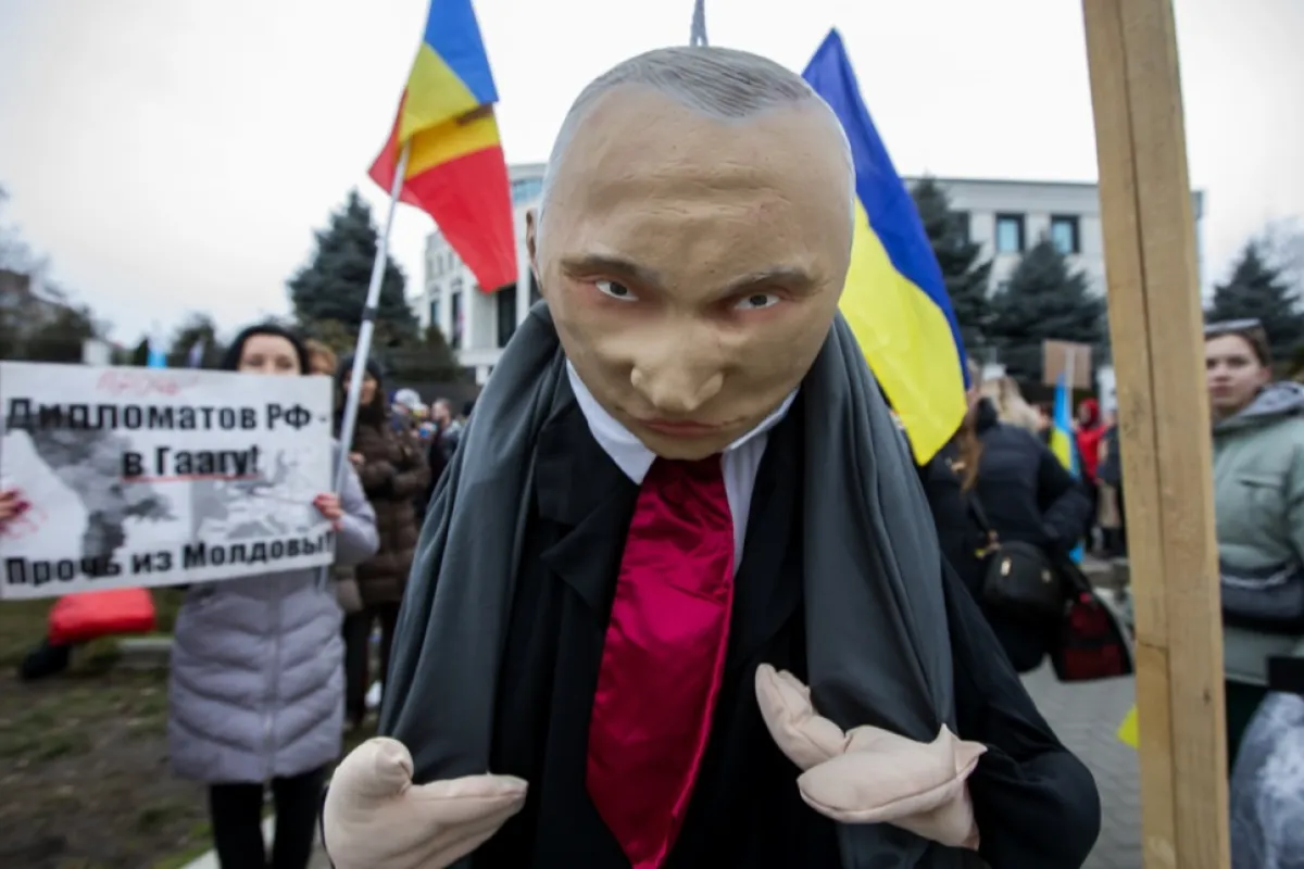 O marionetă a președintelui rus Putin fotografiată în timp ce refugiați ucraineni și cetățeni moldoveni protestează împotriva războiului din Ucraina în fața Ambasadei Rusiei la Chișinău, Moldova, 24 februarie 2023.
