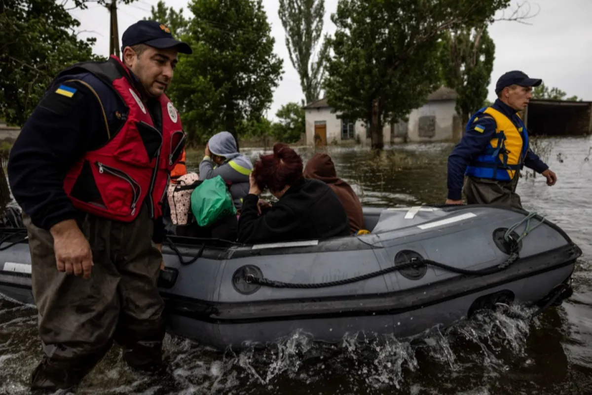 Salvatorii îi ajută pe localnici să ajungă acasă în satul Afanasiivka, regiunea Mykolaiv, Ucraina, 12 iunie 2023, după prăbușirea barajului Nova Kakhovka.