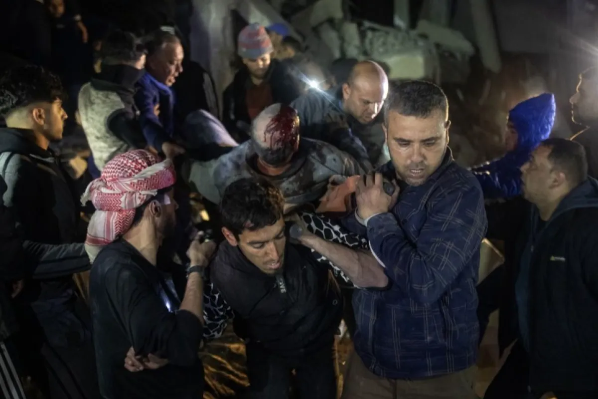 Palestinians search for missing people following an Israeli strike in Rafah camp